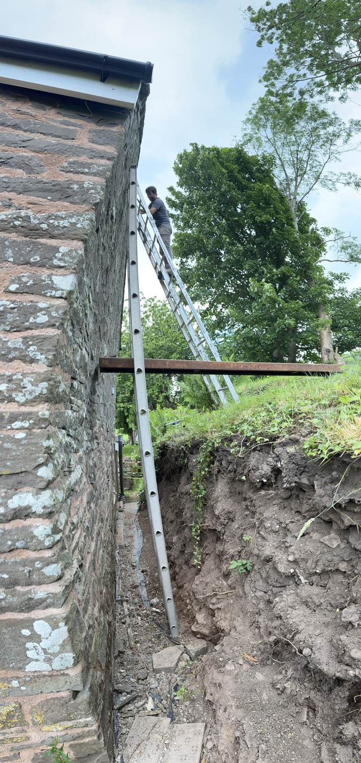 Vertical panorama of repointing work on the stone wall by Tom Jayne, June 2024