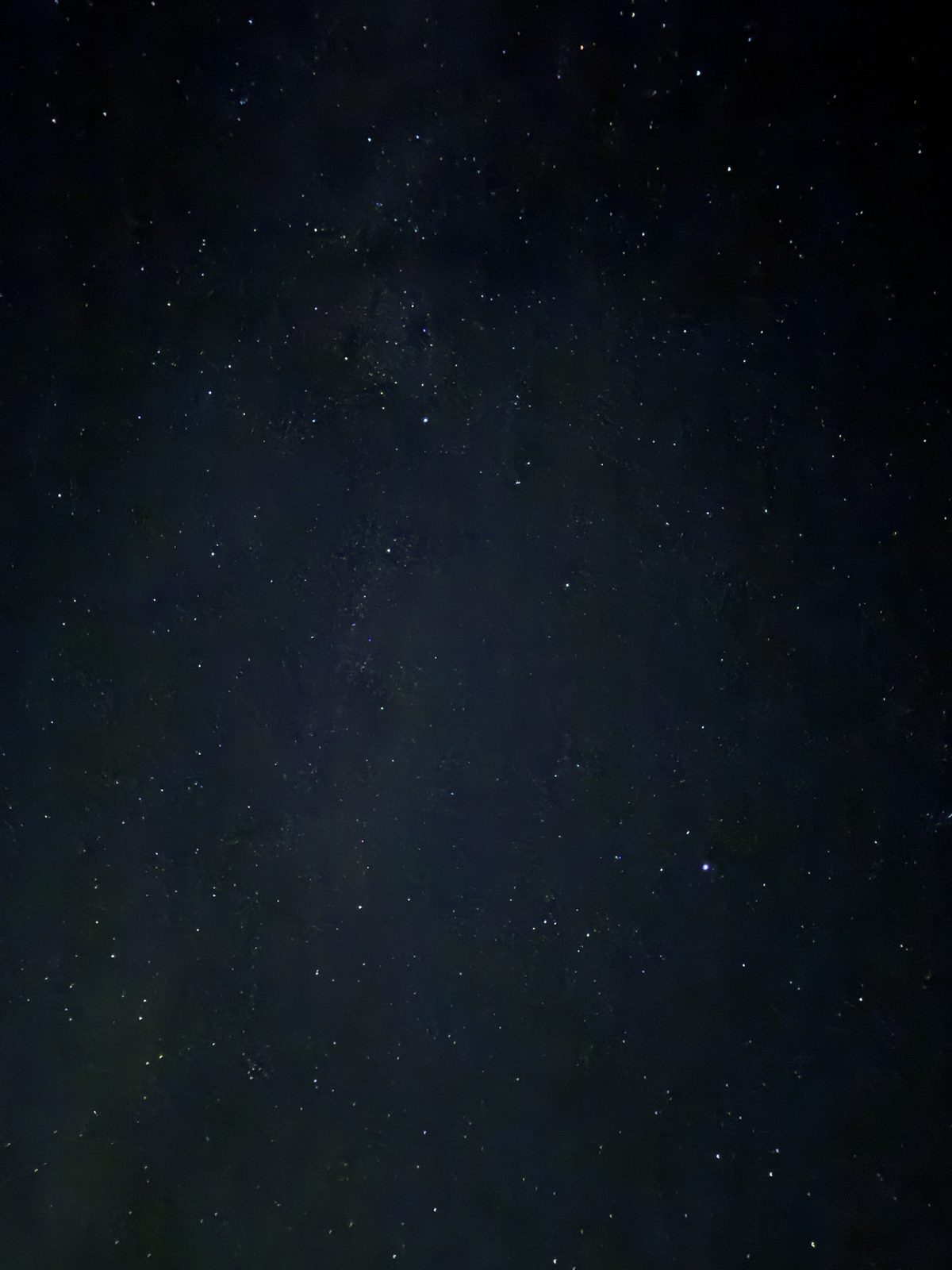 A dark night sky above Pengilfach scattered with stars, the faint band of the Milky Way just visible
